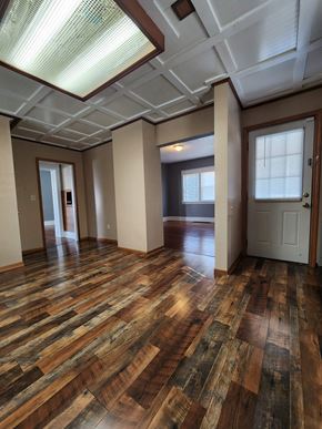 Lima house for rent - an empty living room with wood floors and a door