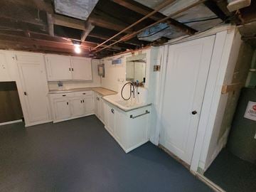 Lima apartment for rent - a kitchen with white cabinets and a sink