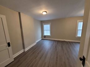 Lima apartment for rent - a empty living room with a hard wood floor and a window