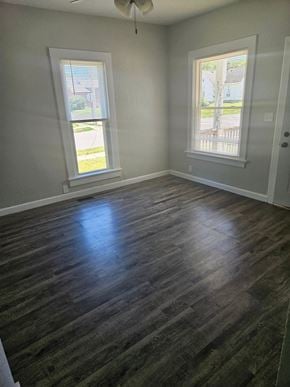 Lima house for rent - an empty living room with wooden floors and two windows