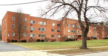 Bedford apartment for rent - a large brick building with a tree in front of it