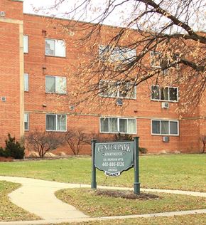 Bedford apartment for rent - a sign in front of a brick building