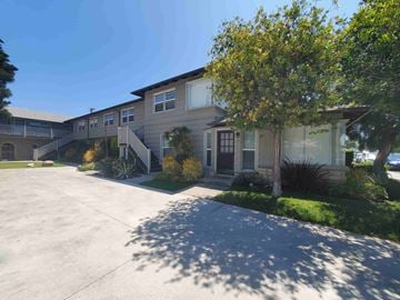 Long Beach apartment for rent - a house with a driveway and a tree in front of it