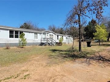 Oklahoma City house for rent - a white house with a yard in front of it