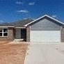 Mustang house for rent - a house with a white garage door in front of it