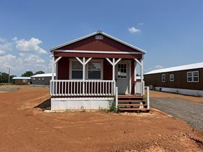 Shawnee house for rent - A small red house with white trim and a porch.