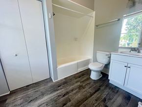 New Albany apartment for rent - a bathroom with a toilet and a tub and a sink