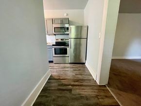 New Albany apartment for rent - a kitchen with stainless steel appliances and a wooden floor