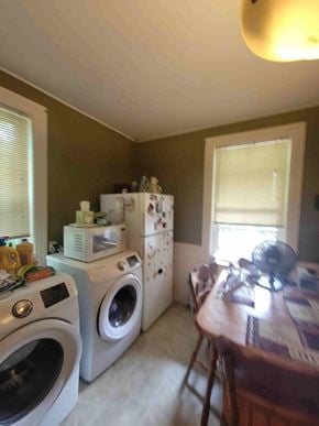 New Glasgow apartment for rent - A laundry room with a washer and dryer stacked on top of each other.