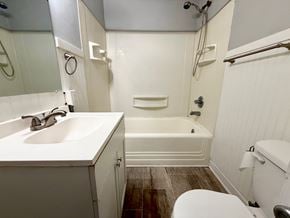New Albany apartment for rent - A white bathroom with a toilet, sink, and bathtub.