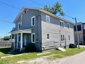 New Albany apartment for rent - A grey house with a white door and windows.