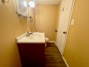 New Albany apartment for rent - A bathroom with a sink, toilet and a mirror.