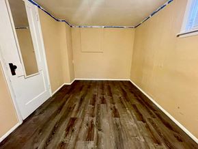 New Albany apartment for rent - A room with wooden flooring and a white door.