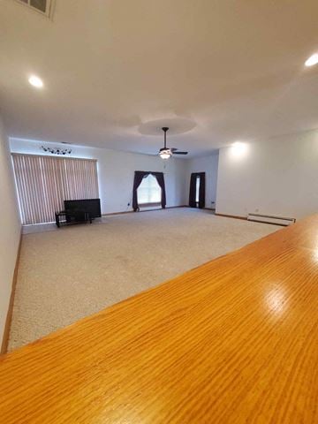 Bluffton house for rent - a large living room with a wooden table and a ceiling fan