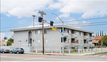 Harbor City apartment for rent - a building with cars parked in front of it at an intersection