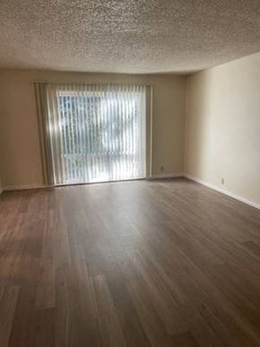 Chico apartment for rent - an empty living room with wood floors and a window