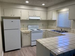 Chico apartment for rent - an empty kitchen with white appliances and white cabinets