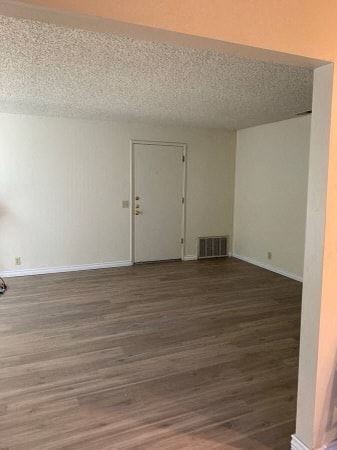Chico apartment for rent - a living room with a wooden floor and a white door