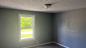 Akron apartment for rent - A room with a window showing greenery outside.