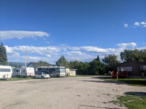 Driggs apartment for rent - a large gravel parking lot filled with parked rvs and tents