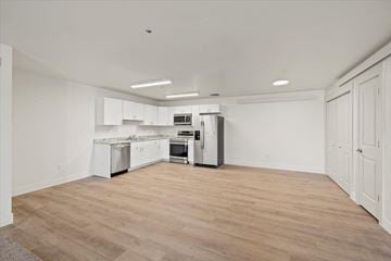 Driggs apartment for rent - an empty kitchen with white cabinets and stainless steel appliances