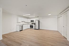 Driggs apartment for rent - an empty kitchen with white cabinets and stainless steel appliances