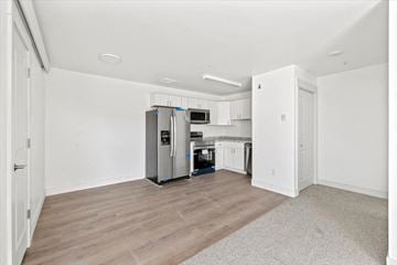 Driggs apartment for rent - a renovated kitchen with white cabinets and a stainless steel refrigerator