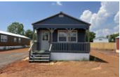 Shawnee house for rent - A small blue house with a porch and a white door.