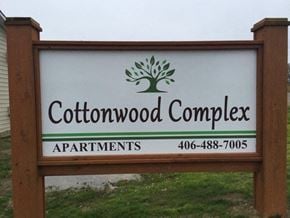 Sidney apartment for rent - a sign for cottonwood complex apartments with a tree on it