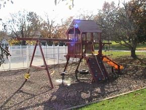Fort Wayne townhouse for rent - a playground with a swing set in a park