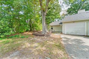 Jacksonville house for rent - A tree in a yard in front of a house.
