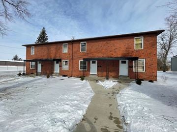 Lima apartment for rent - A red brick house with a snow-covered ground.