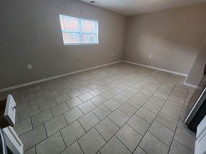 Lima apartment for rent - a empty living room with a window and a tiled floor