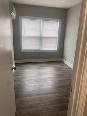 Lima apartment for rent - a empty room with a window and wooden floors
