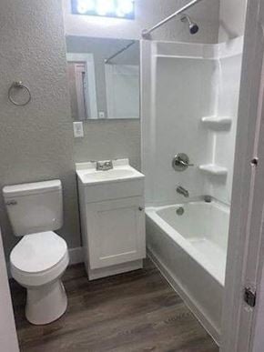 Lima apartment for rent - a bathroom with a toilet and a tub and a sink