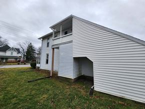 Lima apartment for rent - the side of a white house with a garage door open