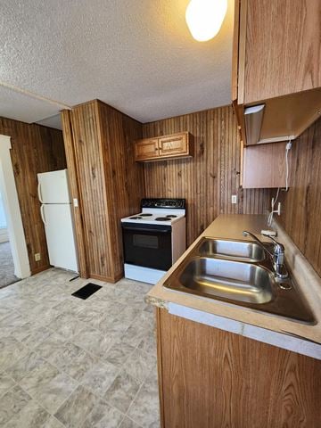 Lima apartment for rent - a kitchen with a sink and a stove and a refrigerator