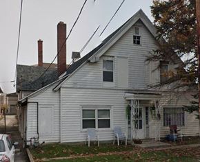 Lima apartment for rent - A white house with a grey roof and a small porch.