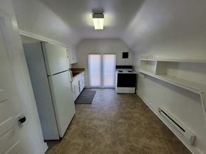 Lima apartment for rent - A kitchen with a refrigerator, sink, and cabinets.