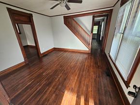 Lima house for rent - A room with wooden floors and a staircase.