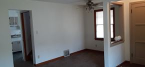 Lima house for rent - an empty room with a ceiling fan and a window