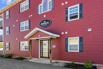 Charlottetown apartment for rent - The front of a red building with a sign that says "The Joshua".