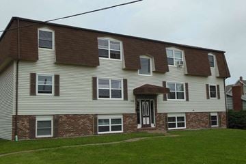 Charlottetown apartment for rent - A two-story house with a brown roof and white siding.