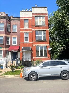 Chicago apartment for rent - a silver car parked in front of a brick building