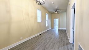 Chicago apartment for rent - an empty living room with wood floors and a ceiling fan
