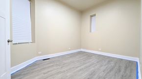 Chicago apartment for rent - an empty room with wood flooring and a window