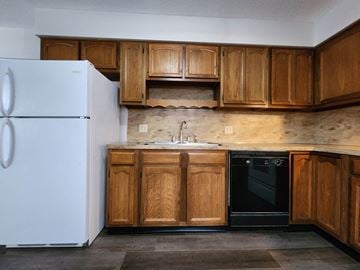Lima apartment for rent - a kitchen with wooden cabinets and a refrigerator