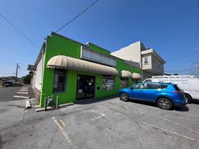 Hagerstown apartment for rent - a green building with a blue car parked outside