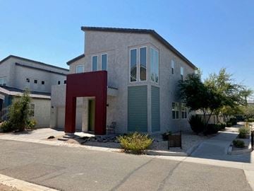 Goodyear house for rent - a gray house with a red structure in front of it