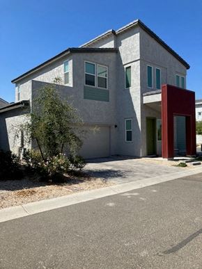 Goodyear house for rent - a gray house with a red door and a driveway